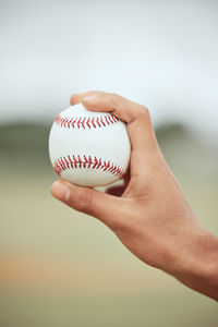 Cropped hand holding baseball