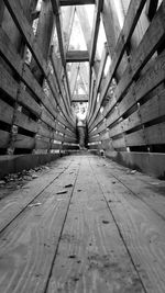 Girl standing by railing of wooden structure