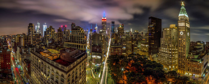 Aerial view of illuminated buildings in city at night