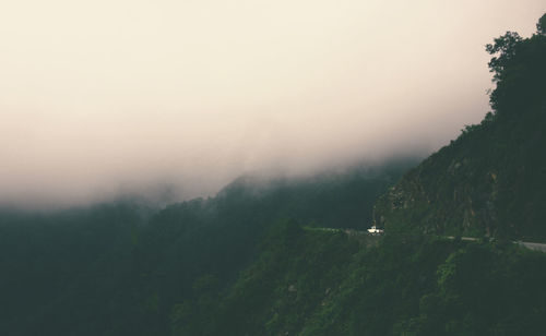 Scenic view of landscape against sky during foggy weather