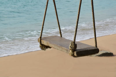 Abandoned boat moored on shore