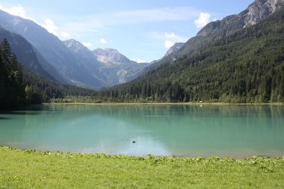 Scenic view of lake and mountains against sky