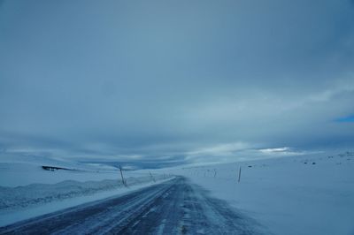 Scenic view of beach against sky during winter