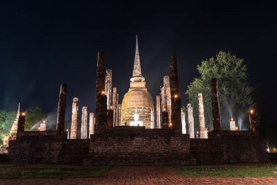 Panoramic view of illuminated building against sky at night