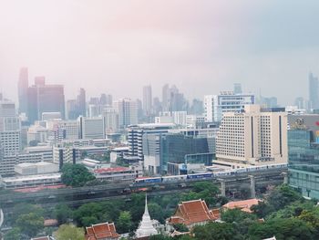 High angle view of buildings in city against sky