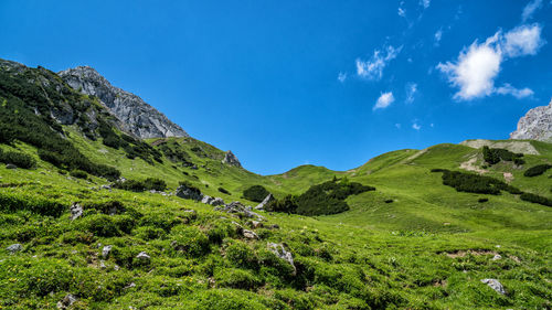 Scenic view of mountains against blue sky