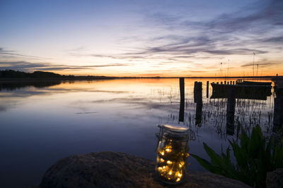 Scenic view of lake against sky during sunset