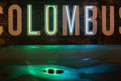 Close-up of illuminated text on wall