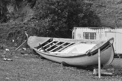 Abandoned boat moored on beach