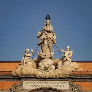 Low angle view of statue against clear blue sky
