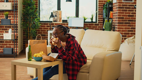 Young woman using laptop at home