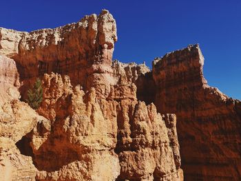 Rock formation against clear blue sky