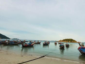 Boats in sea against sky