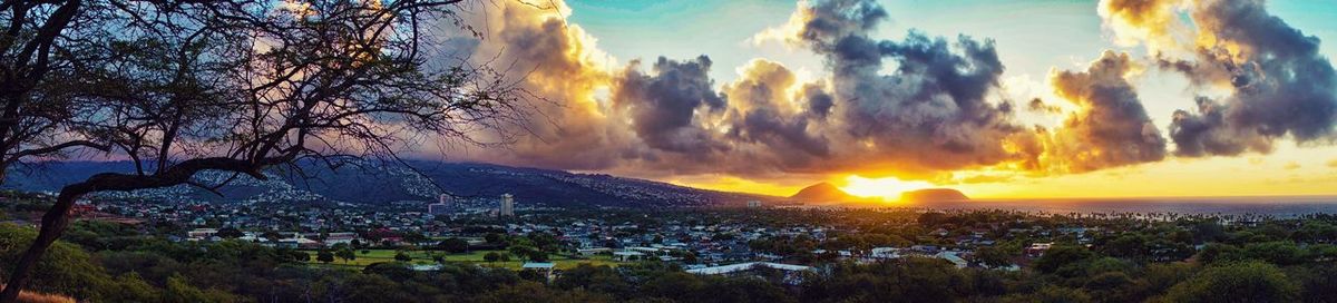Panoramic shot of townscape against sky at sunset