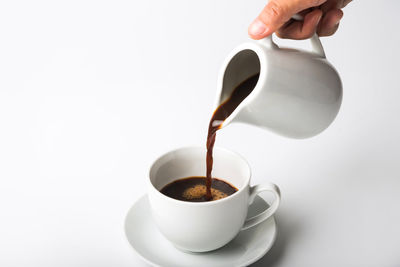 Close-up of coffee cup on white background