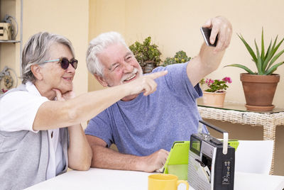 Man taking selfie over smart phone with wife