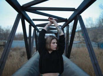 Portrait of beautiful woman sitting on land