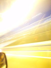 Close-up of yellow car on road