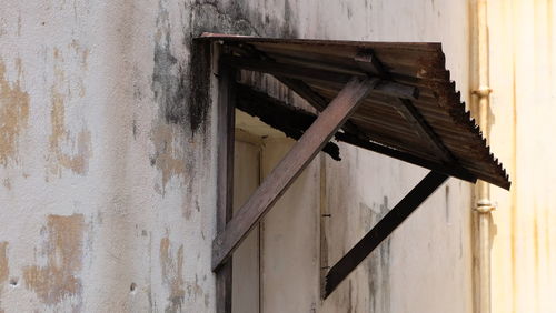 Close-up of wood against built structure