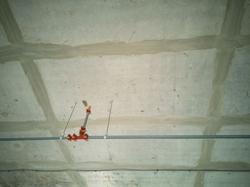 High angle view of worker working on wall