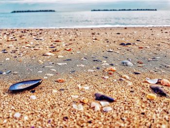 Close-up of sand on beach against sky
