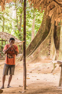 Portrait of man standing in forest