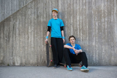 Two teenage boys against concrete wall, stockholm, sweden