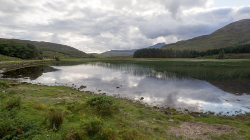 Scenic view of lake and mountains against sky