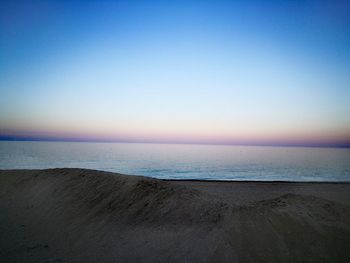 Scenic view of sea against clear sky during sunset