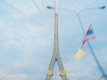 Low angle view of suspension bridge against sky