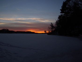 Scenic view of landscape against sky at sunset