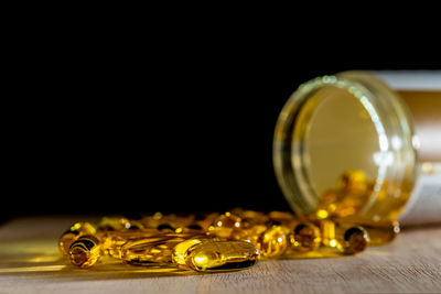 Close-up of glasses on table against black background