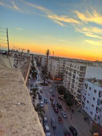 High angle view of traffic on road by buildings against sky