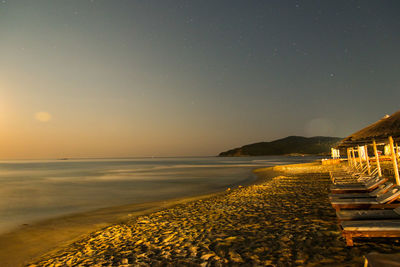 Scenic view of sea against clear sky at sunset