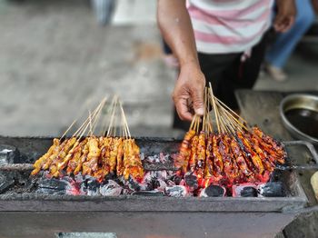 Man preparing food on barbecue grill