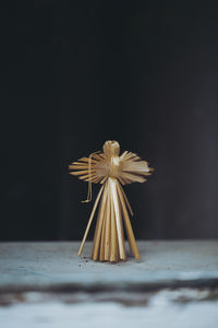 Close-up of straw angel on windowsill