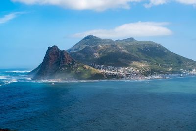 Scenic view of sea and mountains against sky