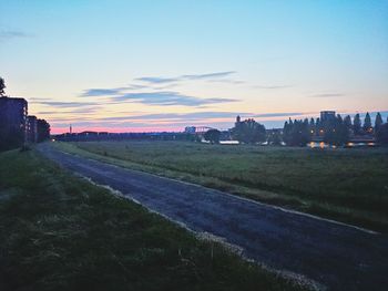 Built structure on landscape at sunset