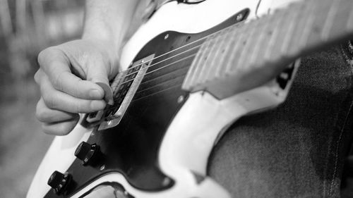 Close-up of hand playing guitar