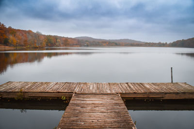 Pier over lake against sky