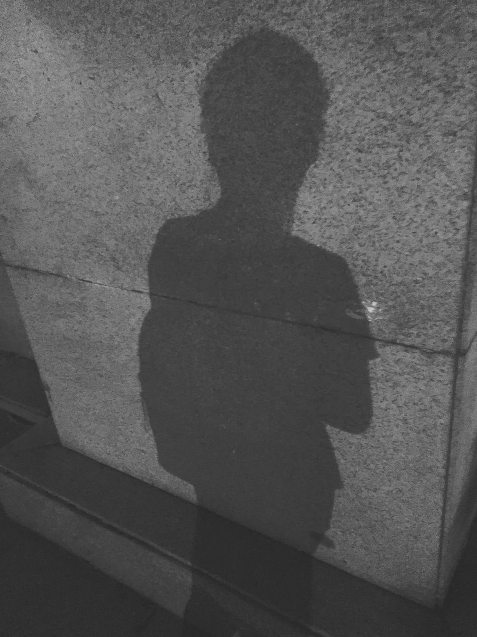 HIGH ANGLE VIEW OF SHADOW ON WALL