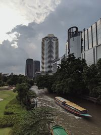 Scenic view of buildings and trees against sky