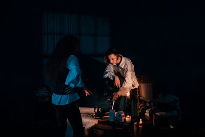 Women standing on table at night