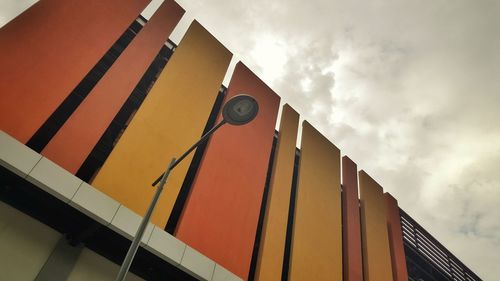 Low angle view of building against cloudy sky