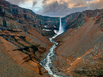 Aerial view on hengifoss waterfall with red stripes sediments in iceland.