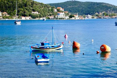 Sailboats moored in sea