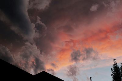 High section of built structure against cloudy sky