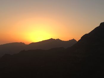 Scenic view of silhouette mountains against sky during sunset