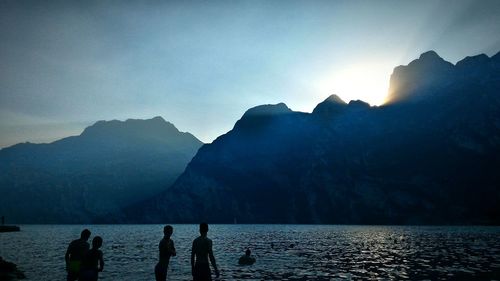 Silhouette of children on river