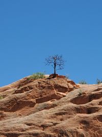 Rock formations against clear blue sky